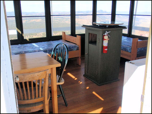 Two beds, table with chairs, fire finder stand