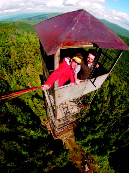 Evan Williams, left, shoots a photograph from a camera attached to a telescope pole last weekend as he and Matt Strickland take in the view from the Wakely Mountain Fire Tower.