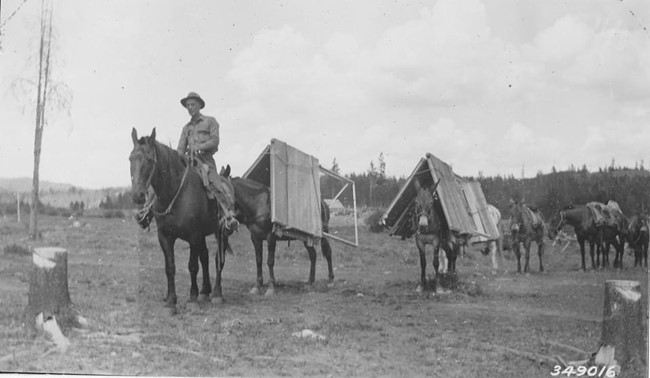 1936 - Emmit Routson with his pack train bringing the lookout tower parts to the remote area when it was first constructed
